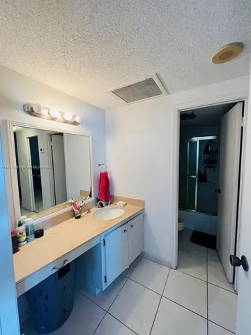 a bathroom with a sink vanity and a mirror