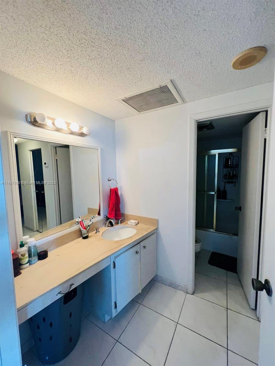 500 Bayview Drive, Unit 1417 Sunny Isles Beach, FL 33160 - Photo 11 of 13 a bathroom with a sink vanity and a mirror