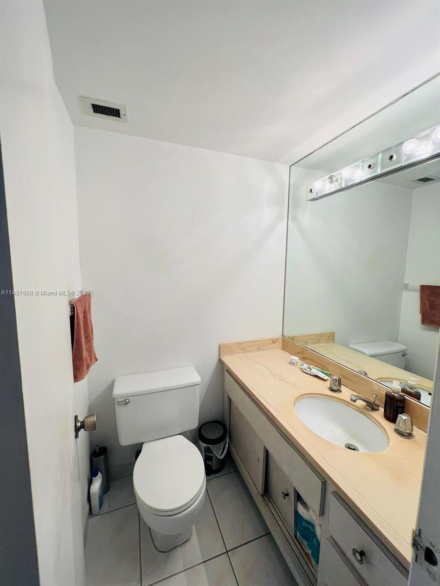500 Bayview Drive, Unit 1417 Sunny Isles Beach, FL 33160 - Photo 12 of 13 a bathroom with a sink toilet vanity and tub