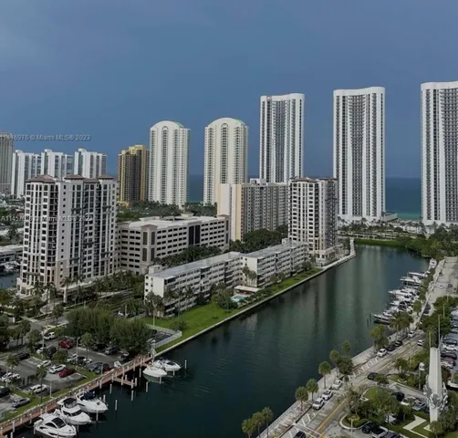 a view of a balcony with chairs and wooden floor