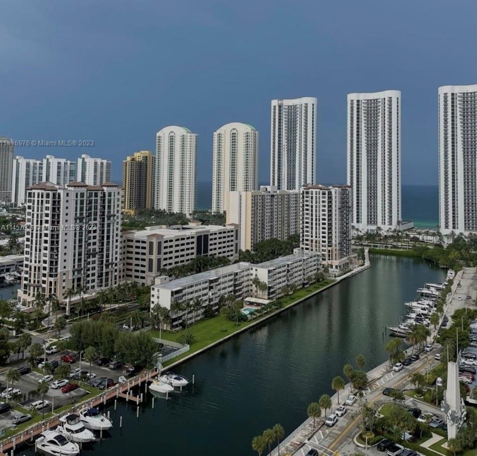 500 Bayview Drive, Unit 1417 Sunny Isles Beach, FL 33160 - Photo 2 of 13 a view of a balcony with chairs and wooden floor
