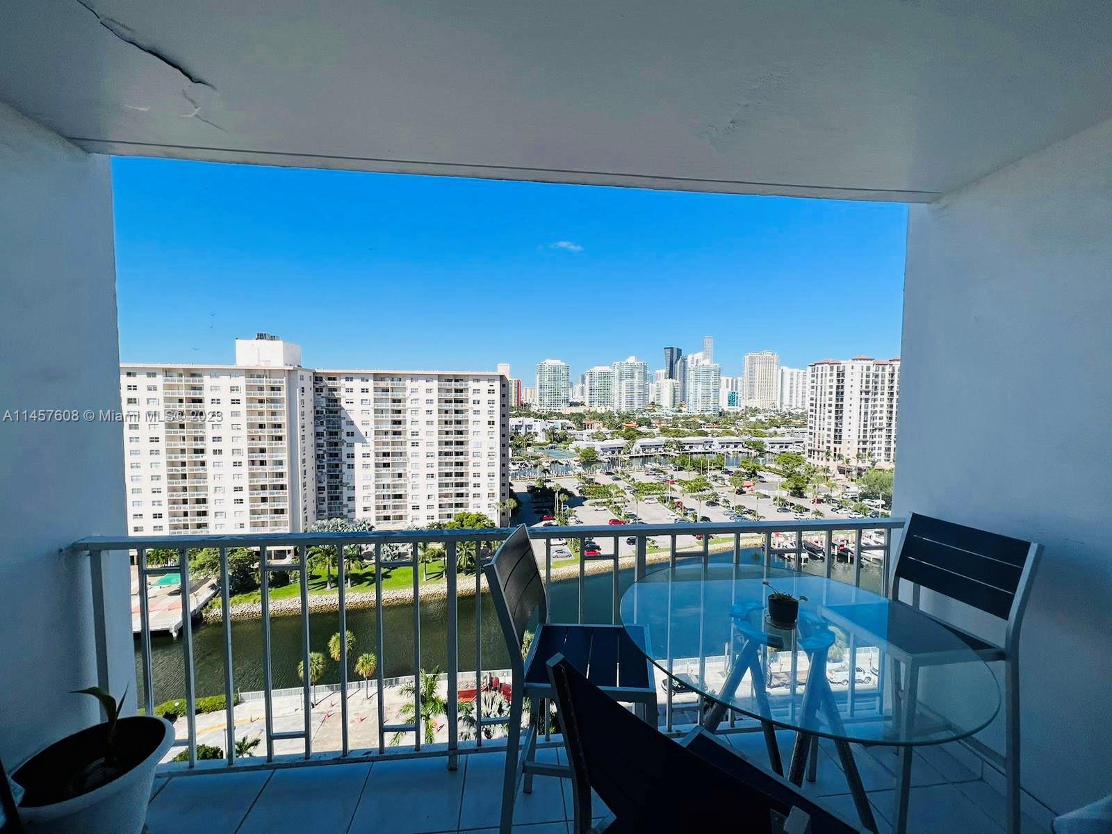 500 Bayview Drive, Unit 1417 Sunny Isles Beach, FL 33160 - Photo 5 of 13 a view of a dining room with furniture window and wooden floor