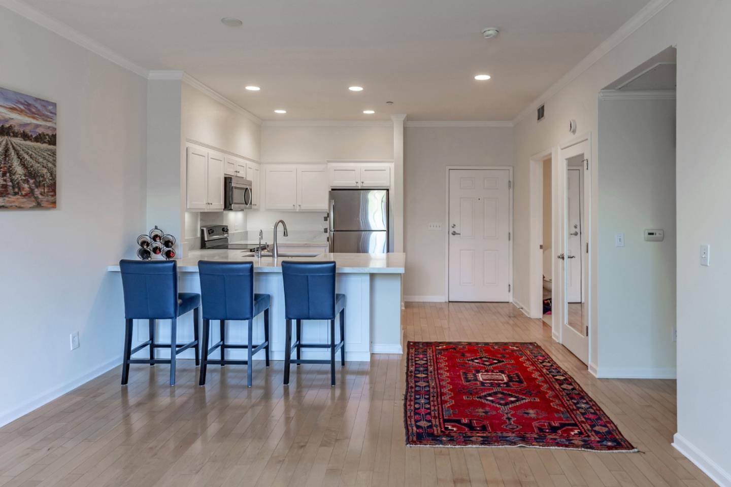 21 North 2nd Street, Unit 303 Campbell, CA 95008 - Photo 12 of 29 a large kitchen with dining table chairs and cabinets