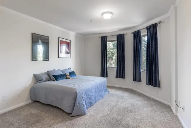 a bedroom with a large bed and a window