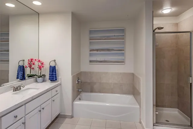 a bathroom with a tub sink and mirror