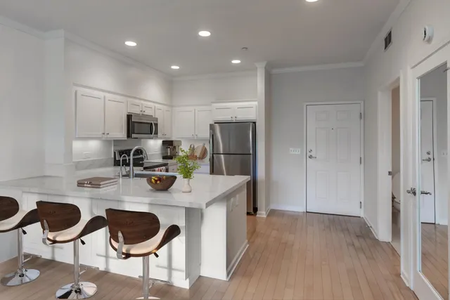 a kitchen with refrigerator and cabinets