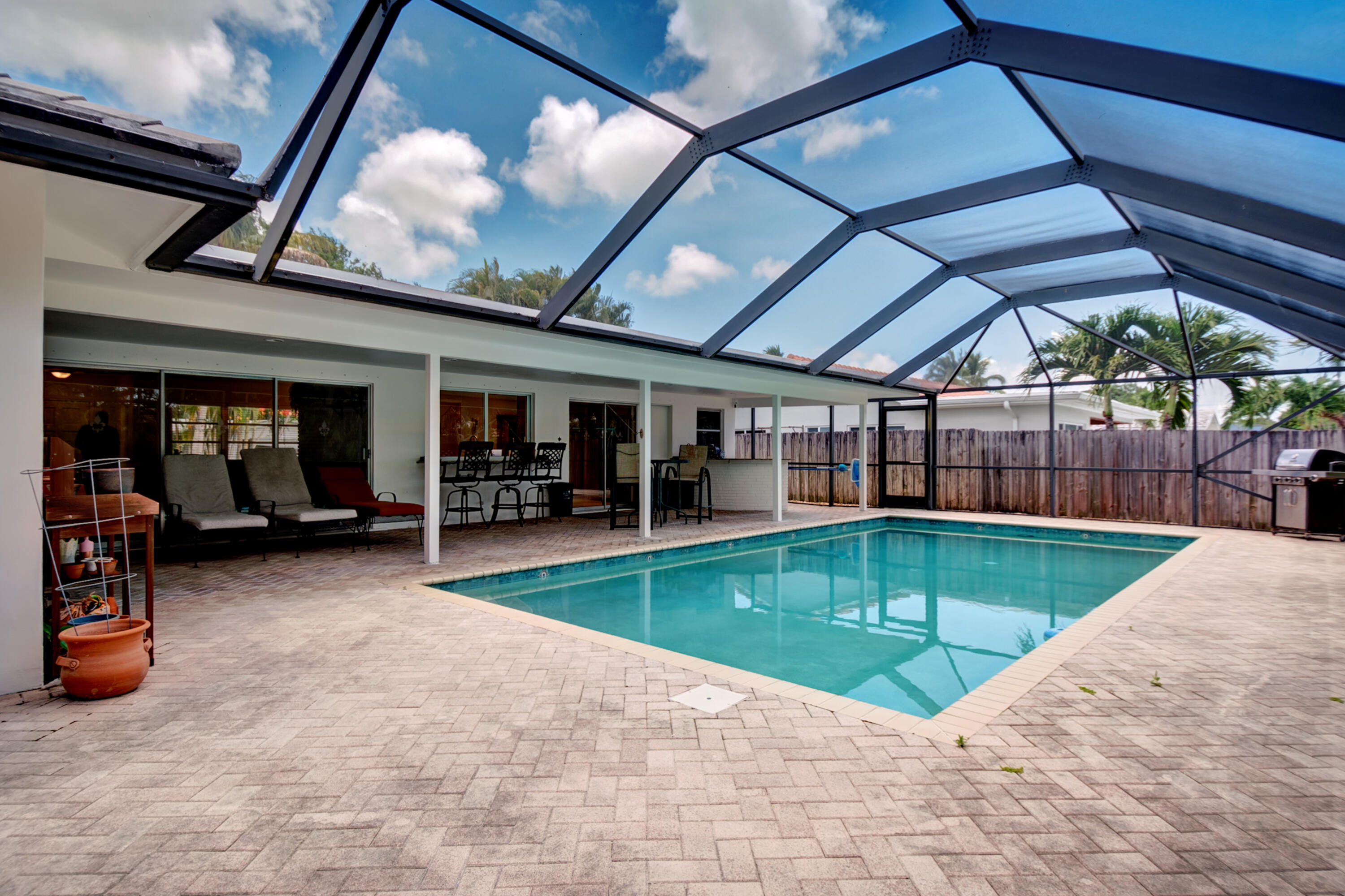 1348 Southwest 4th Street Boca Raton, FL 33486 - Photo 26 of 44 a view of a swimming pool with a patio and a yard