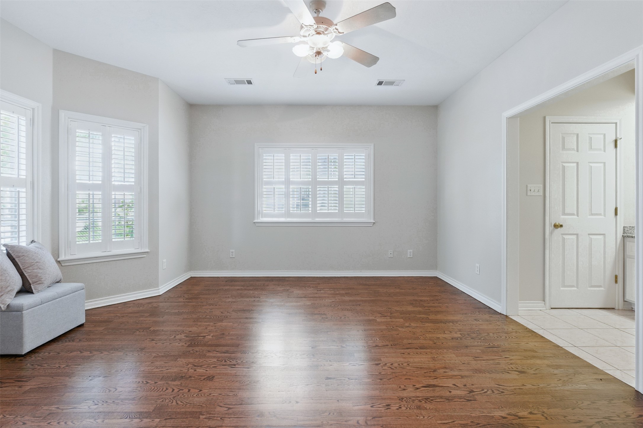 407 West Main Street Brenham, TX 77833 - Photo 19 of 50 a view of an empty room with wooden floor and a window