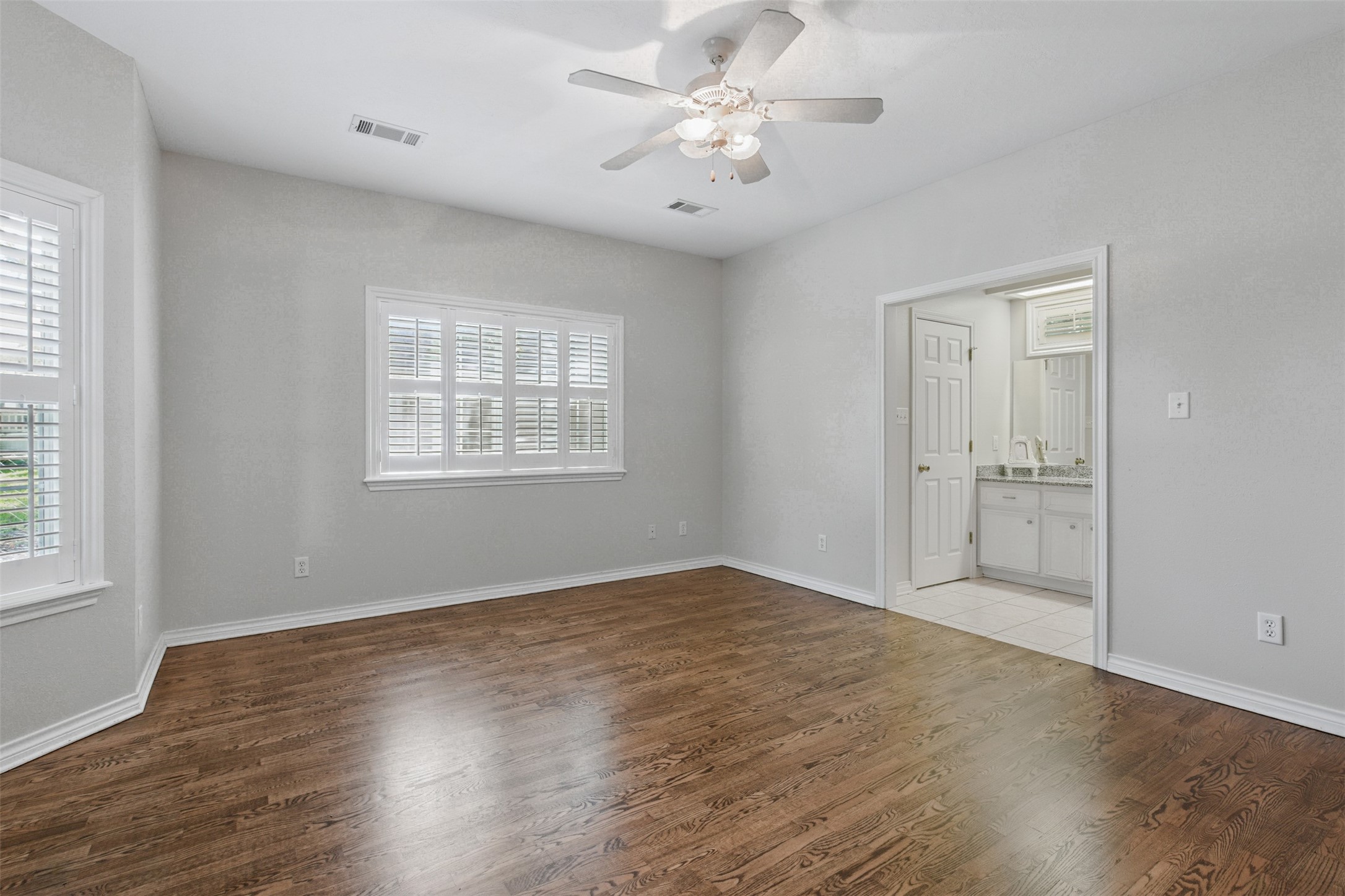 407 West Main Street Brenham, TX 77833 - Photo 20 of 50 wooden floor in an empty room with a window