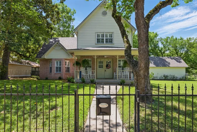 a front view of a house with a garden