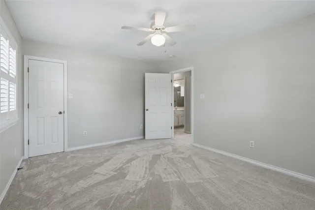 an aerial view of residential house with outdoor space and trees all around