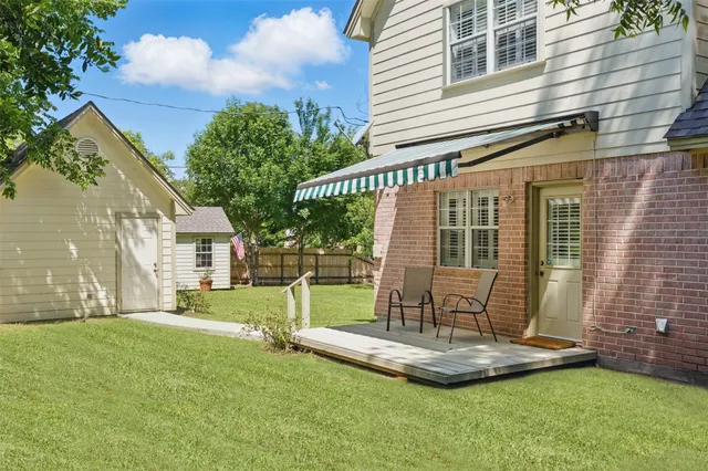 a view of a garden with plants and large trees