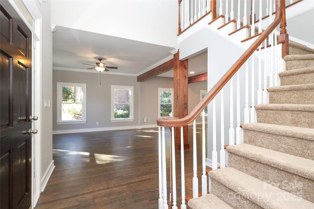 a view of an entryway with wooden floor and door