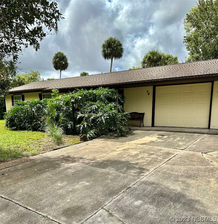 2410 Lime Tree Drive Edgewater, FL 32141 - Photo 2 of 18 a front view of a house with a yard and garage