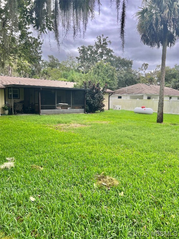 2410 Lime Tree Drive Edgewater, FL 32141 - Photo 3 of 18 a backyard of a house with plants and large tree
