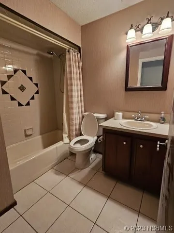 a bathroom with a double vanity sink toilet mirror and bathtub