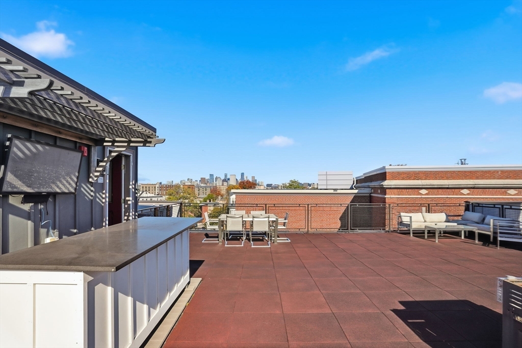 246 Boston Street, Unit 9 Boston, MA 02125 - Photo 17 of 24 a terrace with a city view