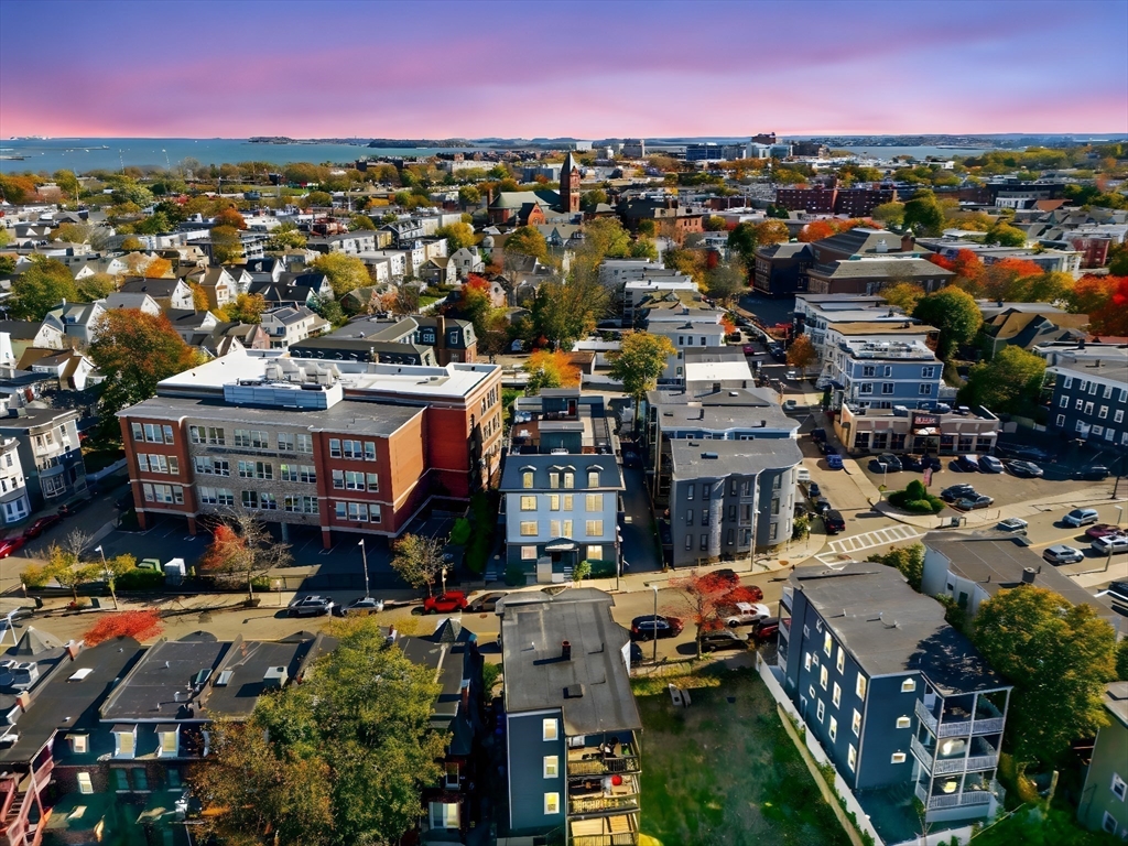 246 Boston Street, Unit 9 Boston, MA 02125 - Photo 24 of 24 an aerial view of city with lots of residential buildings ocean and mountain view in back