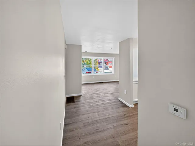 a view of an empty room and wooden floor