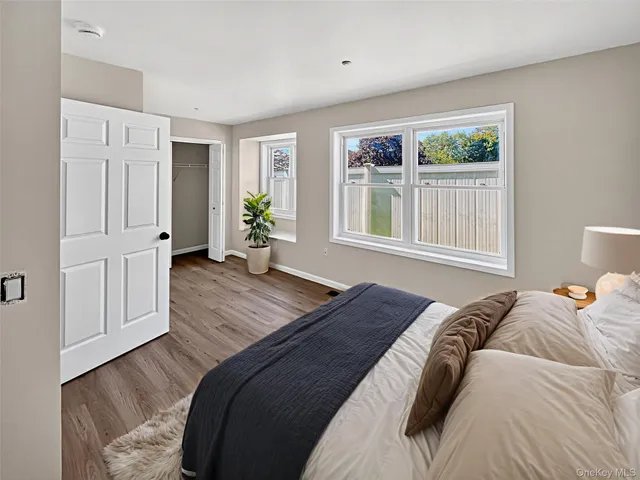 a bed sitting in a bedroom next to a window