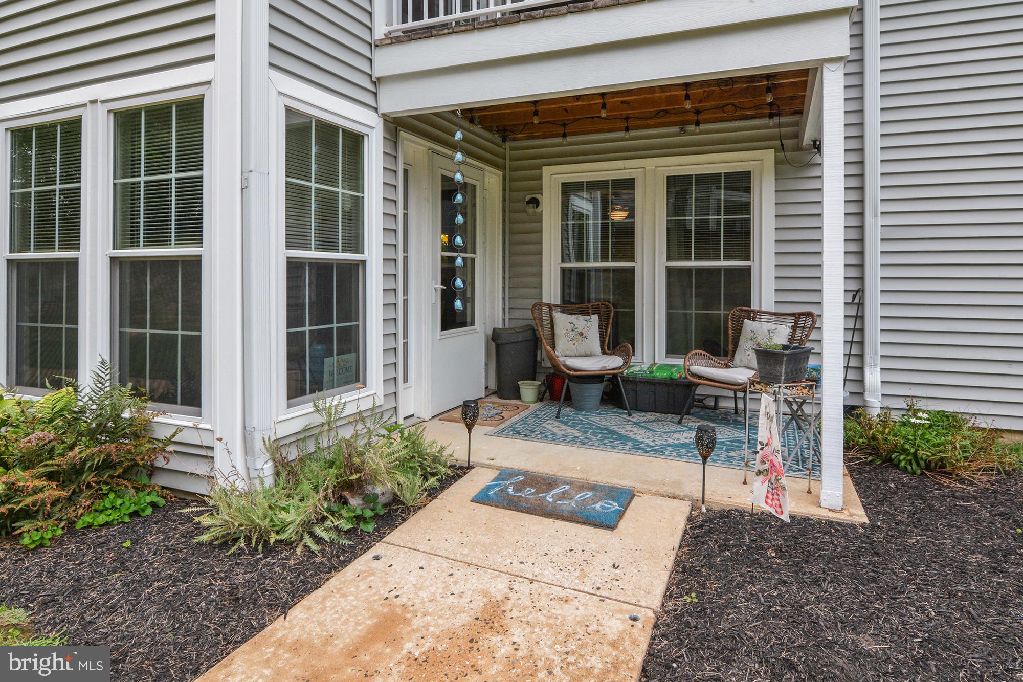 1402 Golden Rod Court, Unit 5 Belcamp, MD 21017 - Photo 25 of 28 a front view of a house with a bench and potted plants