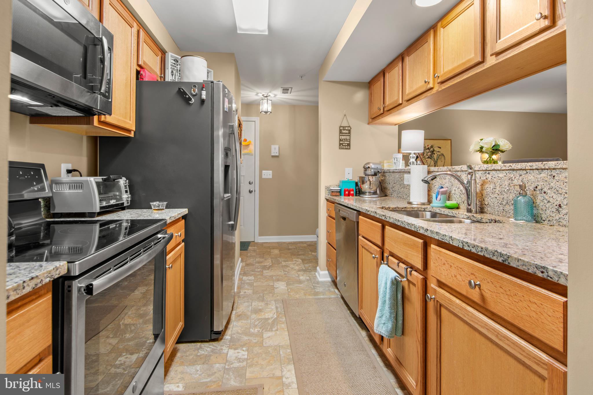 1402 Golden Rod Court, Unit 5 Belcamp, MD 21017 - Photo 3 of 28 a kitchen with stainless steel appliances granite countertop a stove a sink and a refrigerator