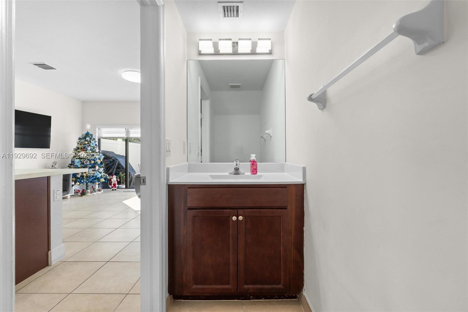 3272 West 92nd Place Hialeah, FL 33018 - Photo 11 of 37 a bathroom with a sink and a mirror