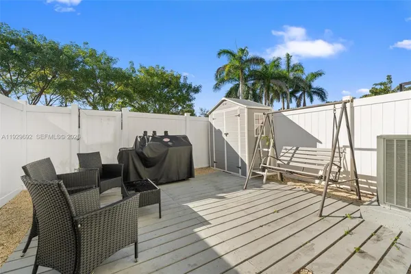 a balcony with furniture and a potted plant