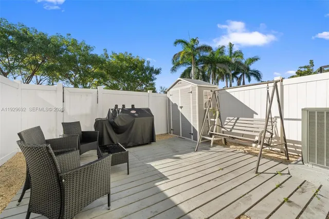 a balcony with furniture and a potted plant