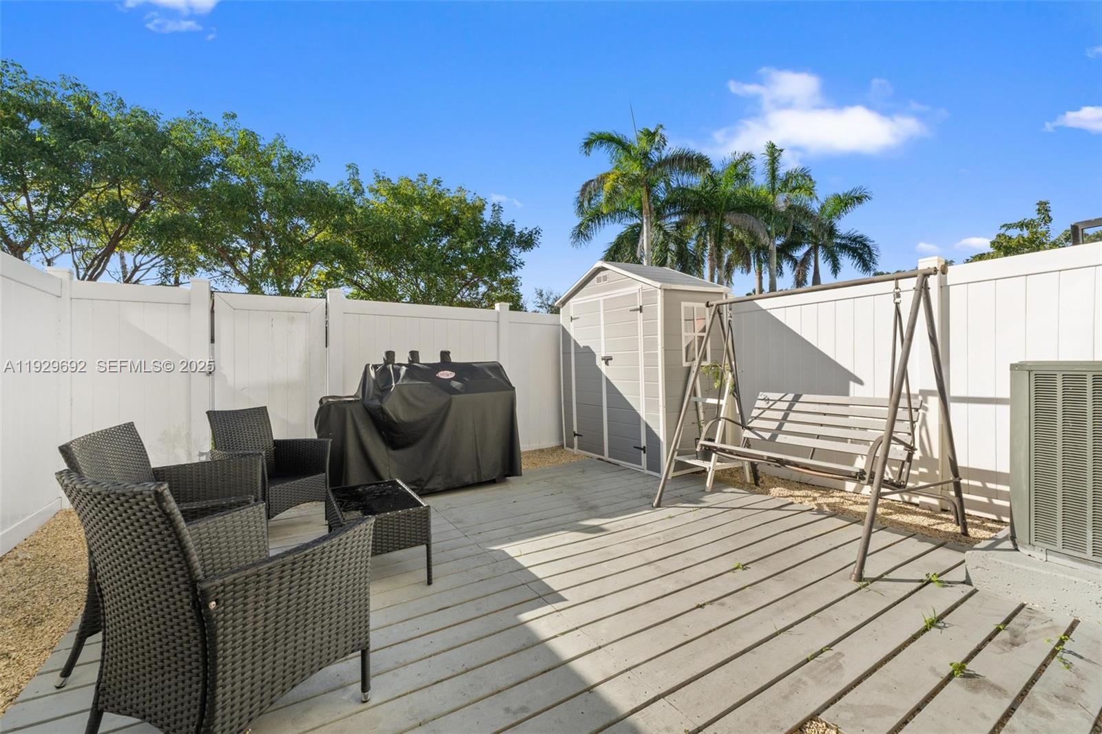 3272 West 92nd Place Hialeah, FL 33018 - Photo 14 of 37 a balcony with furniture and a potted plant