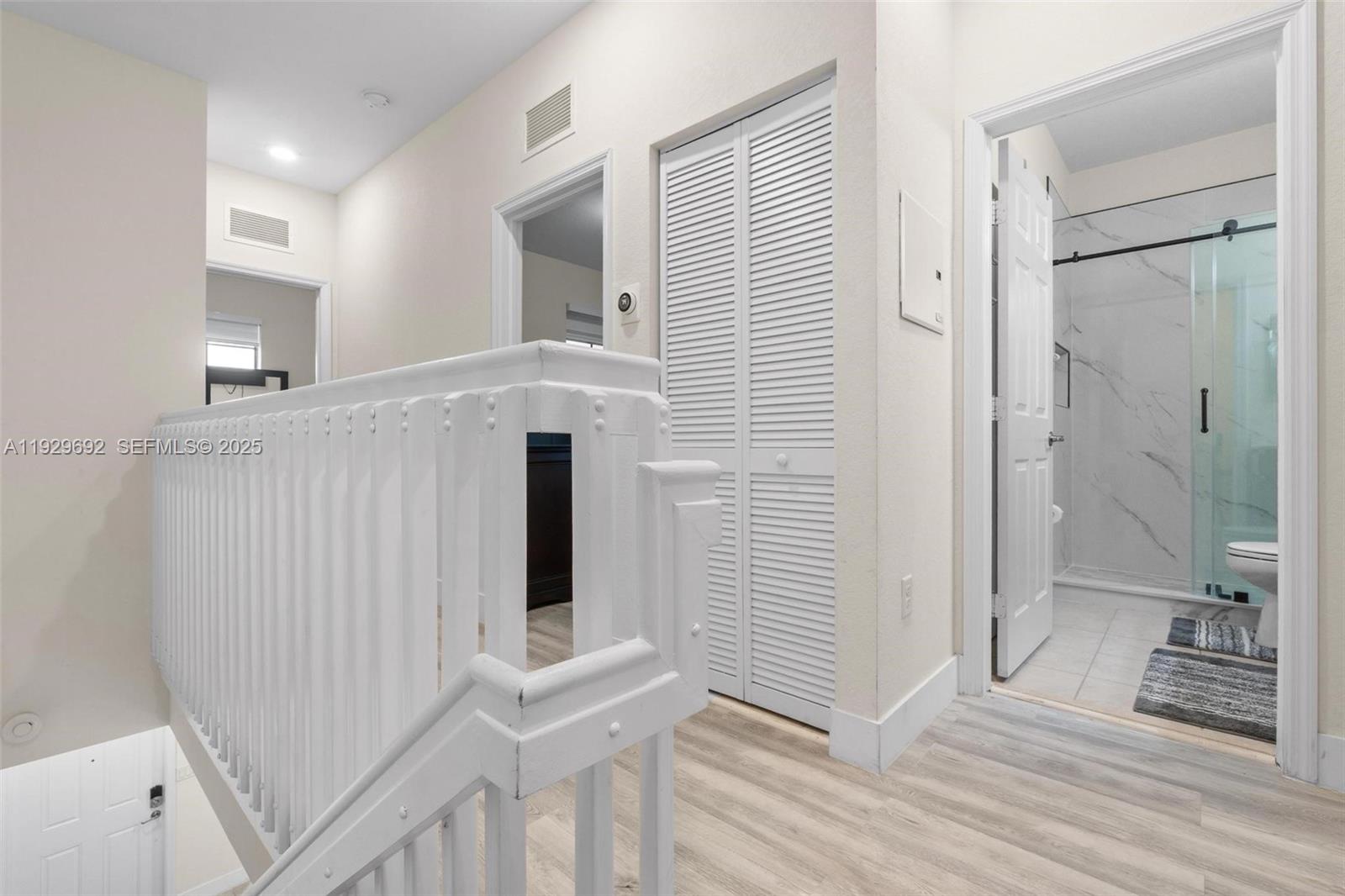 3272 West 92nd Place Hialeah, FL 33018 - Photo 16 of 37 a view of a hallway with entryway and wooden floor