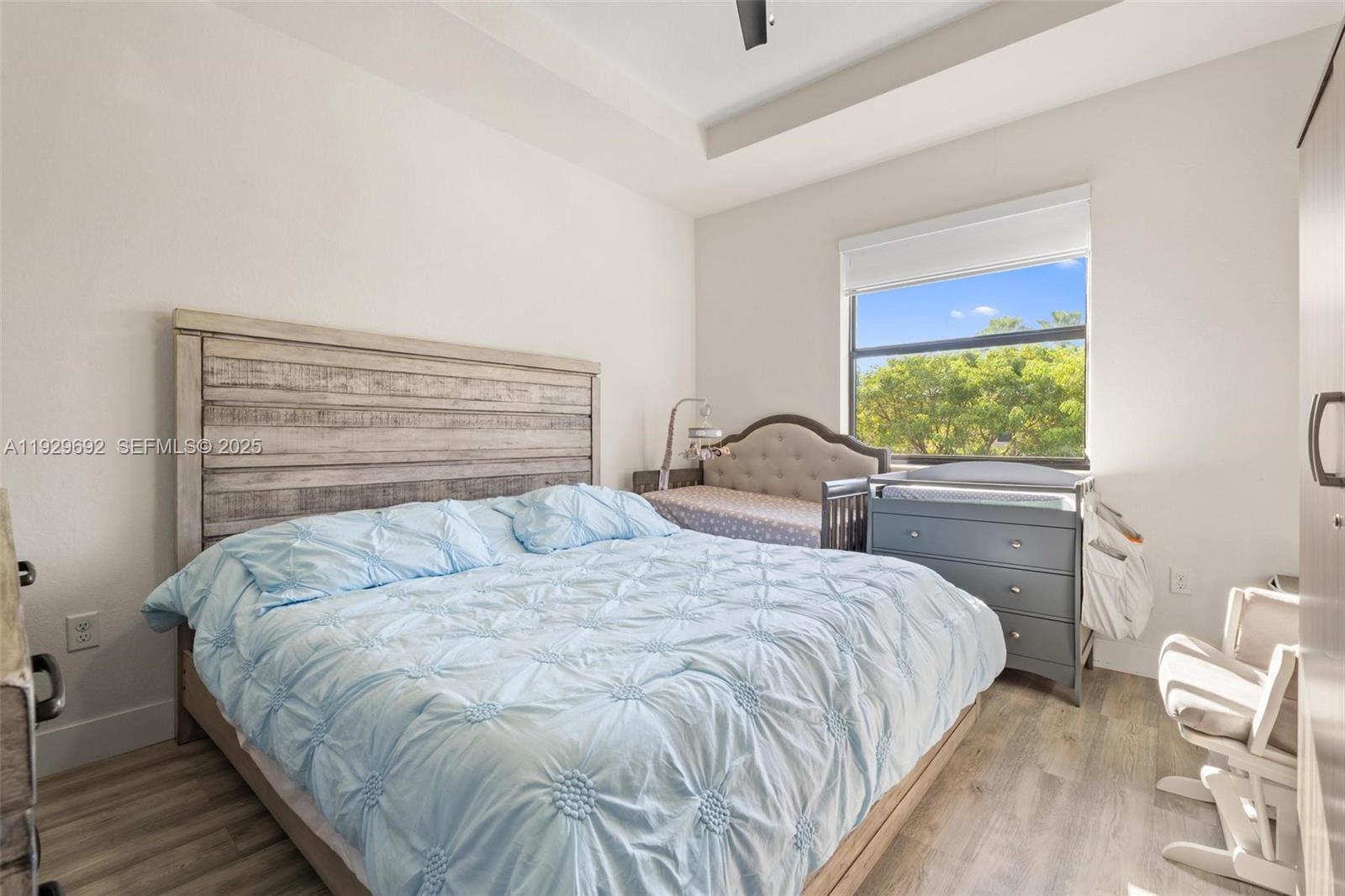 3272 West 92nd Place Hialeah, FL 33018 - Photo 18 of 37 a bedroom with a bed and a large window
