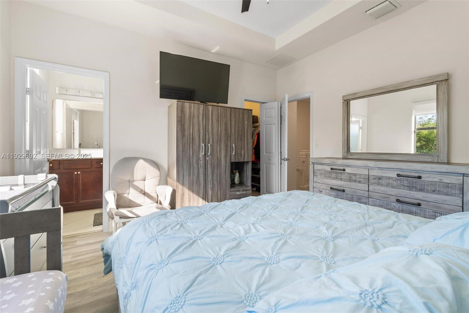 3272 West 92nd Place Hialeah, FL 33018 - Photo 19 of 37 a large bedroom with a bed and a television