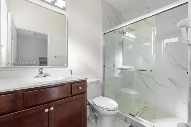 a bathroom with a sink toilet and shower