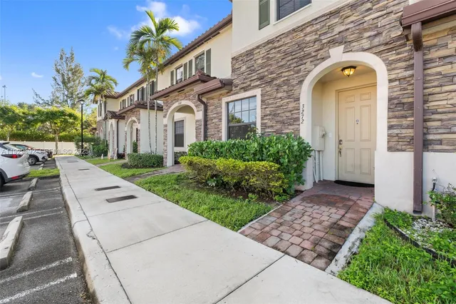 a view of a brick house with a large windows