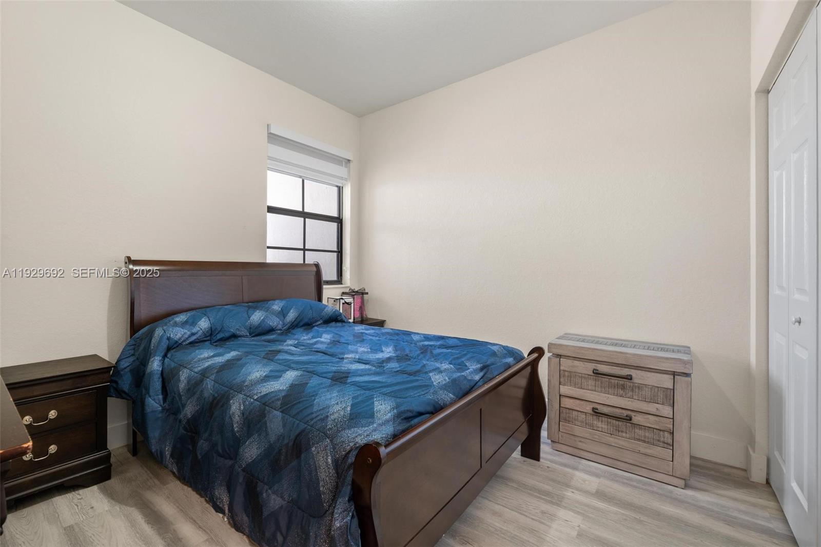 3272 West 92nd Place Hialeah, FL 33018 - Photo 21 of 37 a bed sitting in a bedroom next to a window