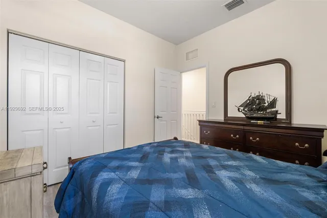 a bedroom with a bed and a dresser