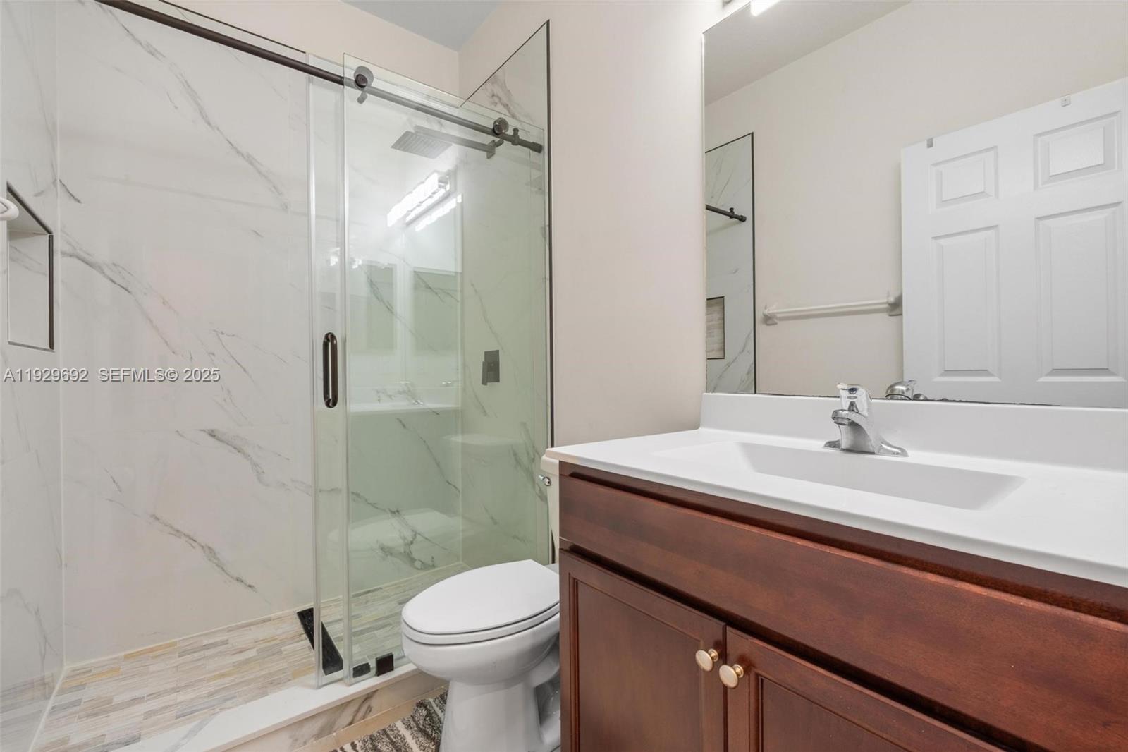 3272 West 92nd Place Hialeah, FL 33018 - Photo 23 of 37 a bathroom with a sink a toilet and shower