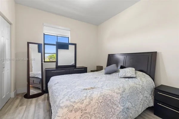 a bedroom with a bed and wooden floor