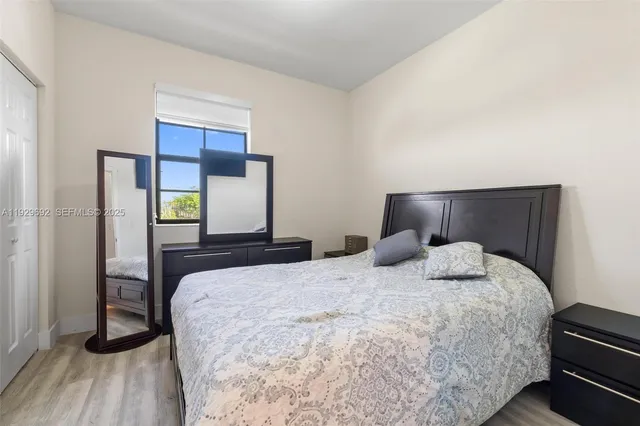 a bedroom with a bed and wooden floor