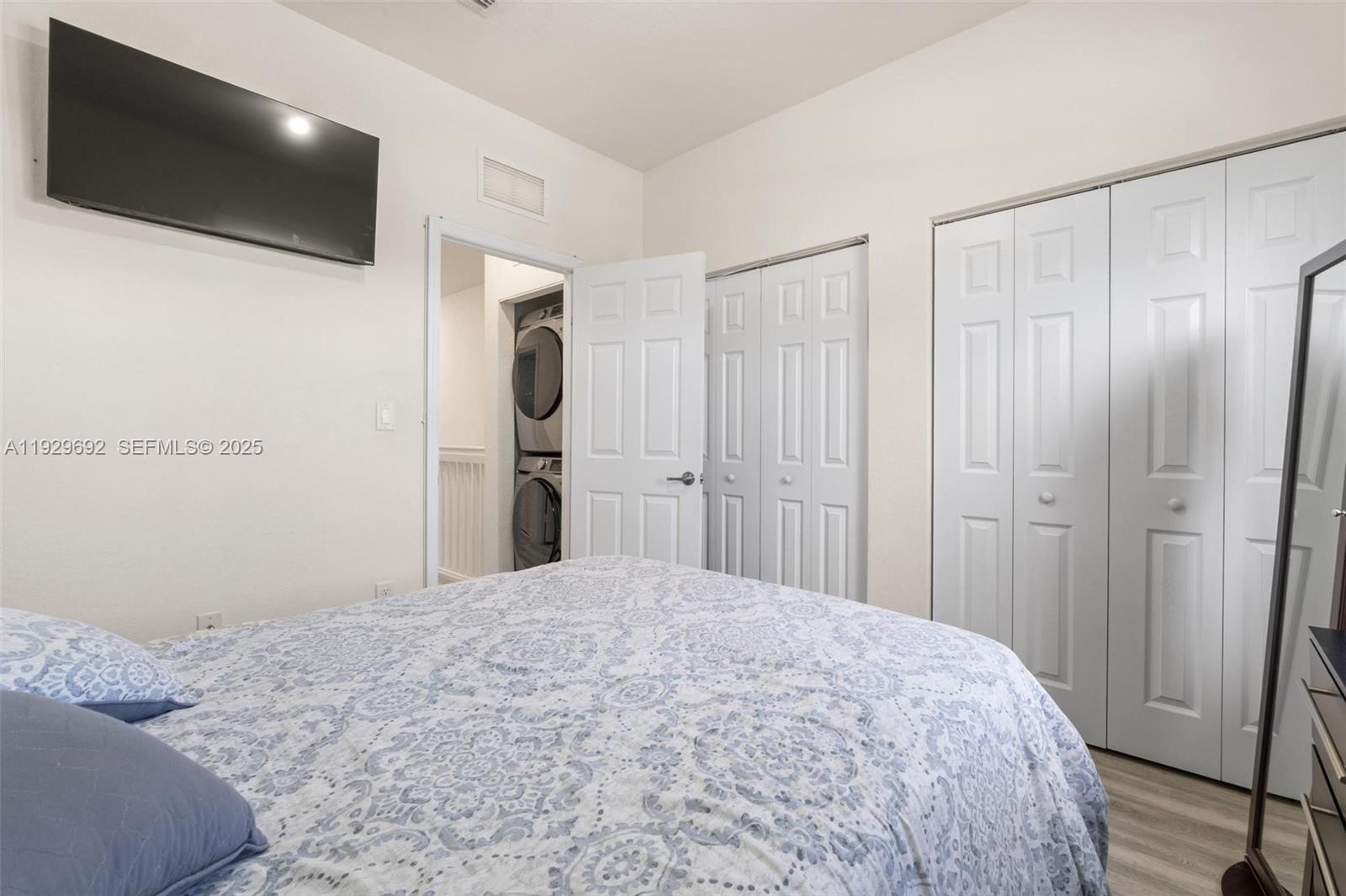 3272 West 92nd Place Hialeah, FL 33018 - Photo 25 of 37 a bedroom with a bed and a flat screen tv