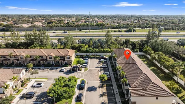 an aerial view of multiple houses with a yard