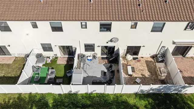an aerial view of lake and residential houses with outdoor space