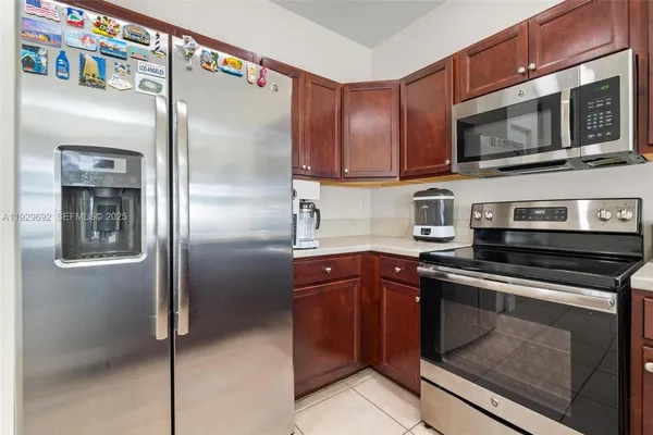 a kitchen with stainless steel appliances granite countertop a stove microwave and refrigerator