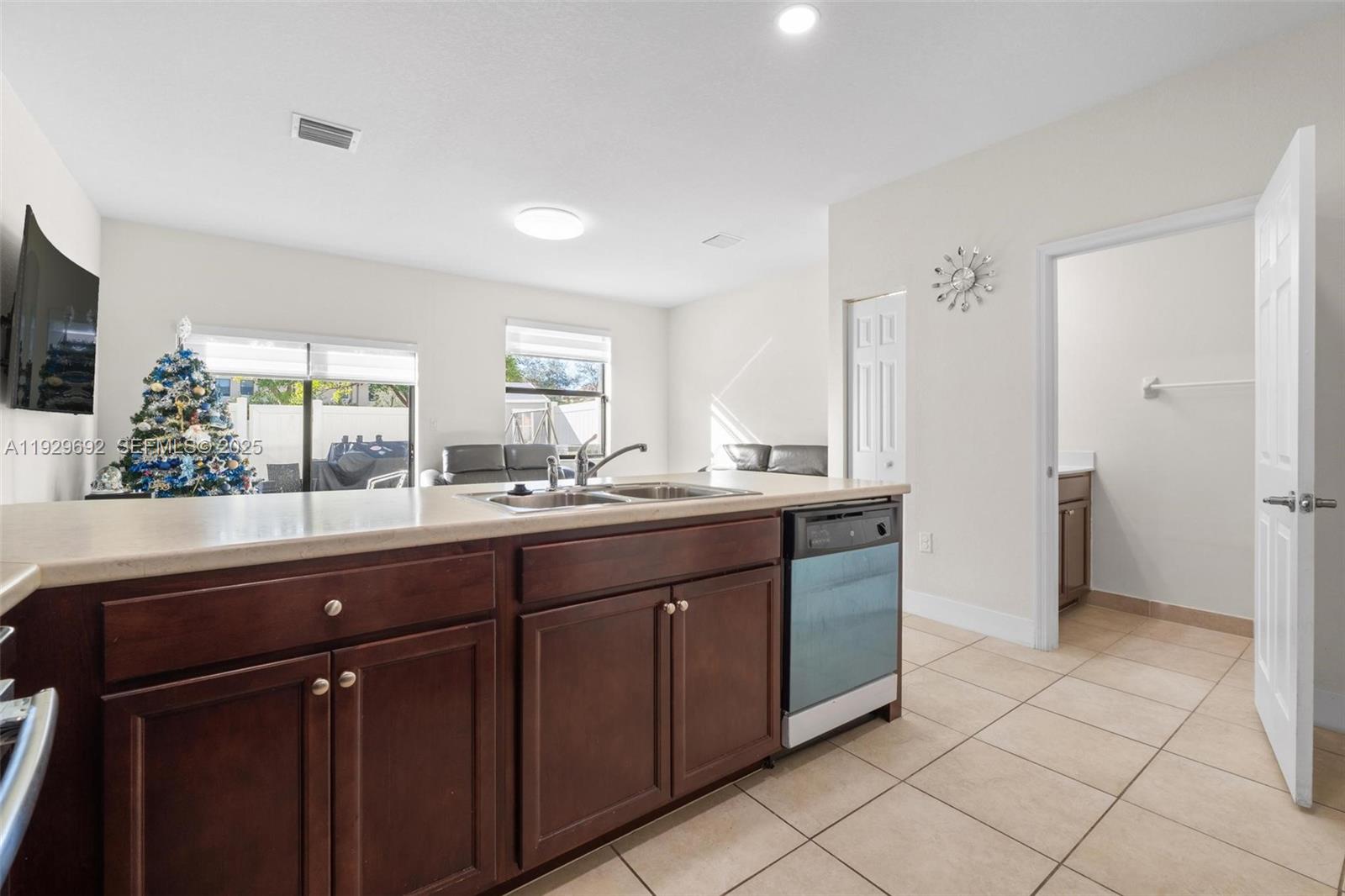3272 West 92nd Place Hialeah, FL 33018 - Photo 10 of 37 a bathroom with a sink a mirror and a window