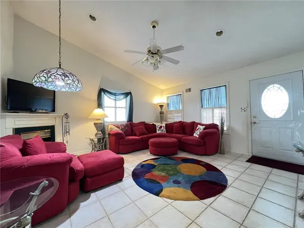 a living room with furniture a chandelier and a mirror