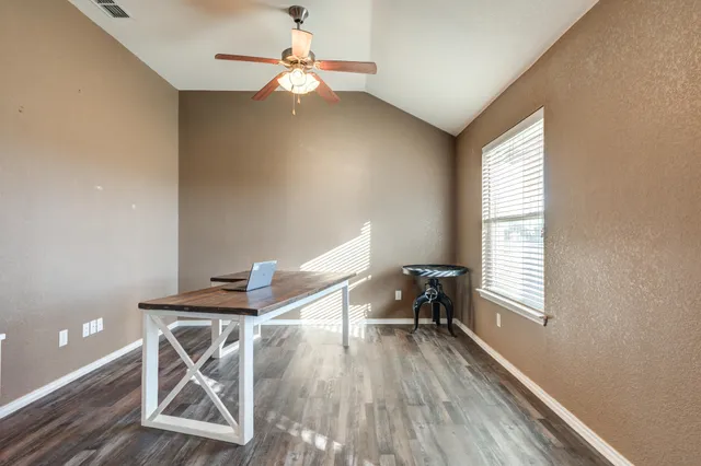 a workspace with furniture and wooden floor