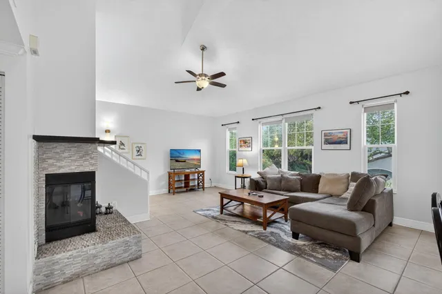a living room with furniture and a fireplace