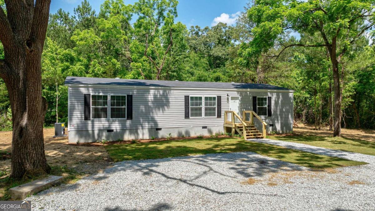 1167 Stinchcomb Road Elberton, GA 30635 - Photo 1 of 1 a front view of a house with a yard patio and fire pit