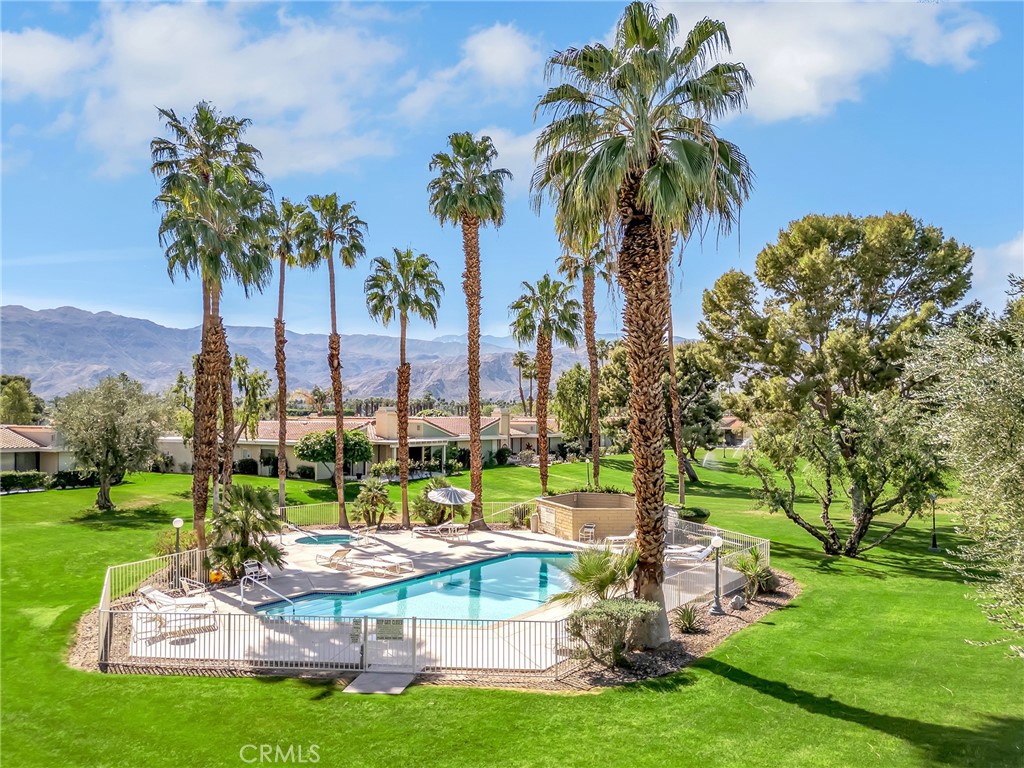 72355 Roxbury Drive Rancho Mirage, CA 92270 - Photo 1 of 61 a view of a swimming pool and trees in a yard